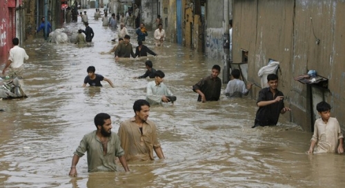 People moving to safety after rain hit karachi